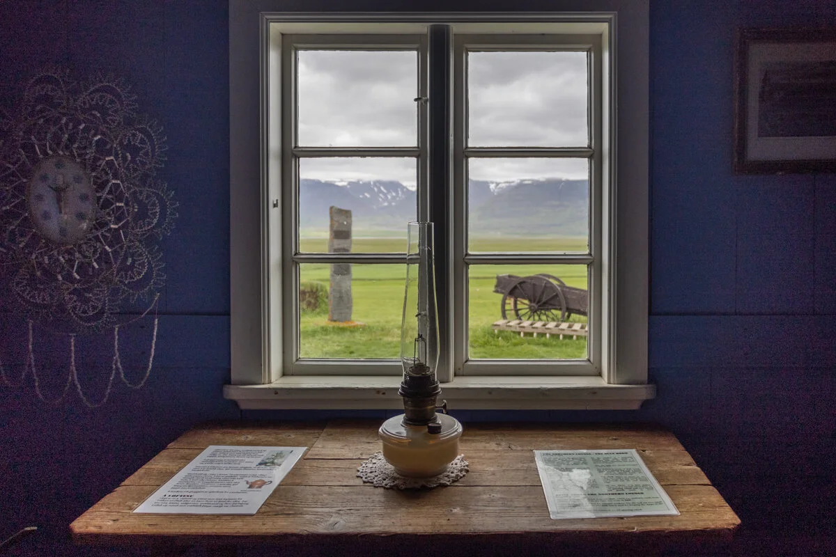 intérieur d'une maison, avec une table devant une fenêtre donnant sur la verdure extérieure